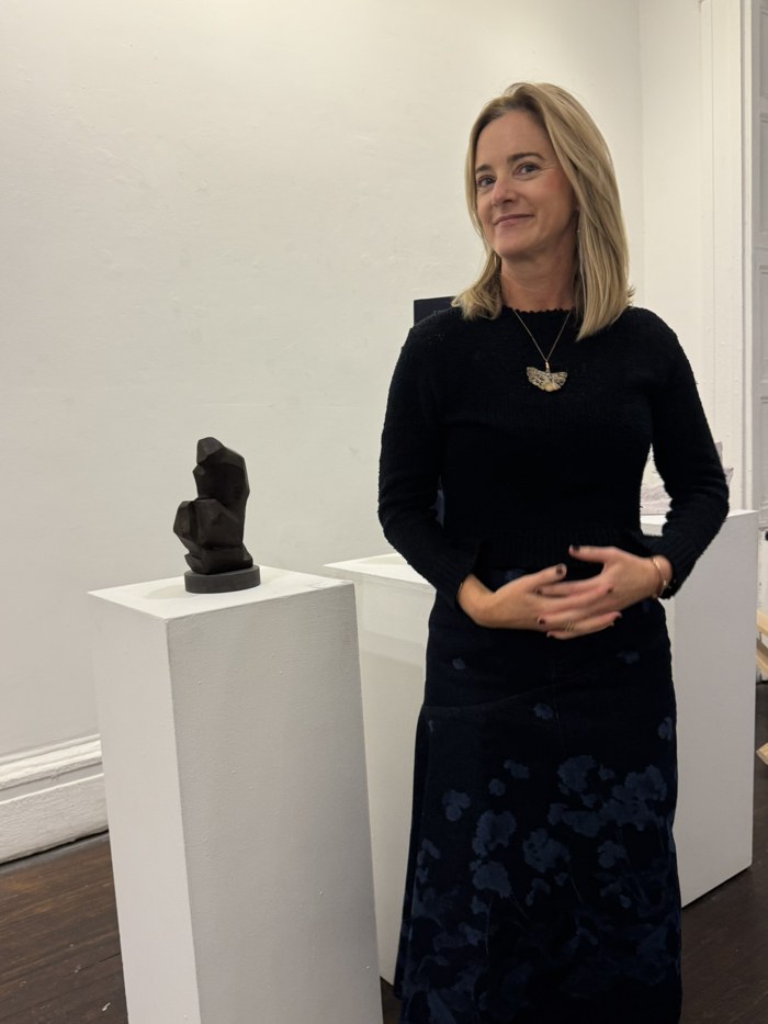 Brooke Brown Barzun beside her sculpture in a gallery